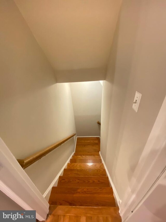 stairway with wood finished floors