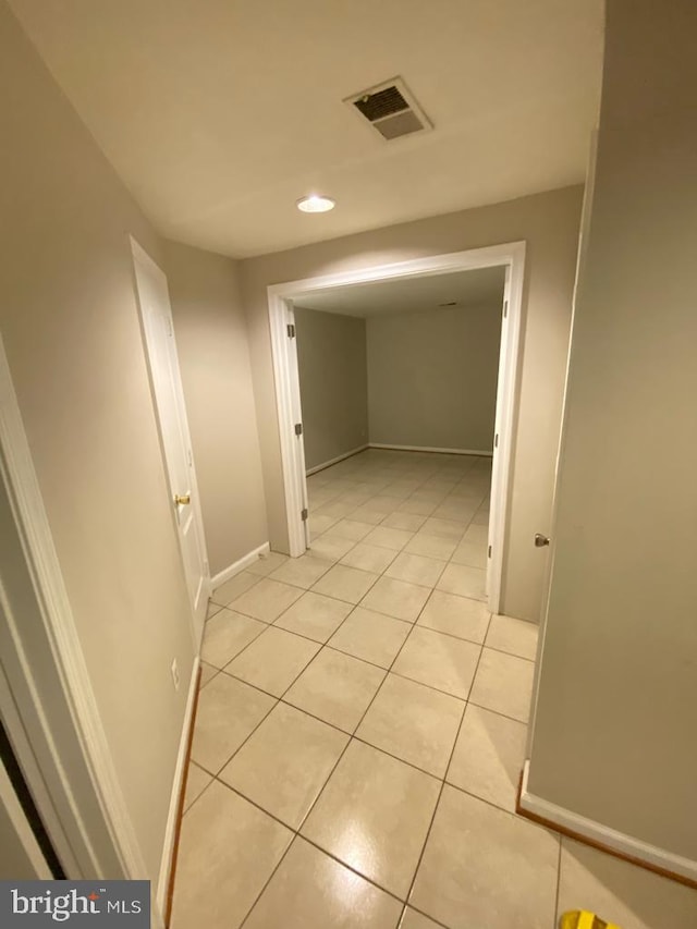 corridor featuring light tile patterned flooring, recessed lighting, and baseboards