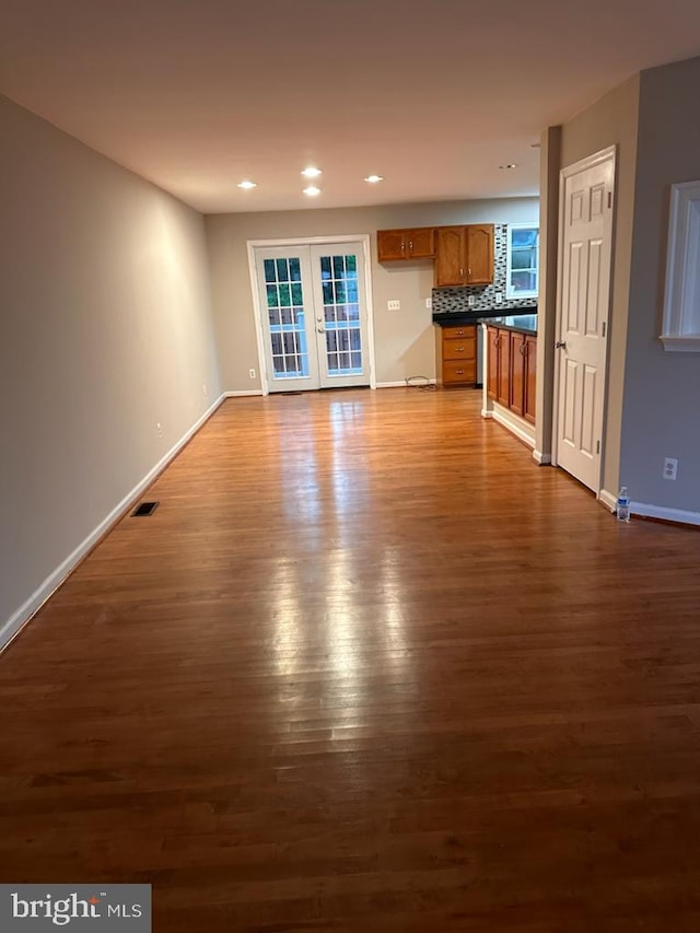 unfurnished living room with dark wood finished floors, baseboards, and recessed lighting
