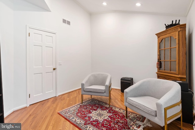 sitting room with visible vents, baseboards, ornamental molding, recessed lighting, and light wood-style flooring