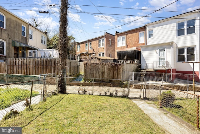 view of yard with a gate and a residential view
