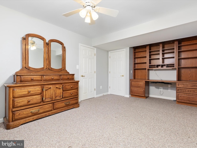 unfurnished bedroom with baseboards, a ceiling fan, and carpet flooring