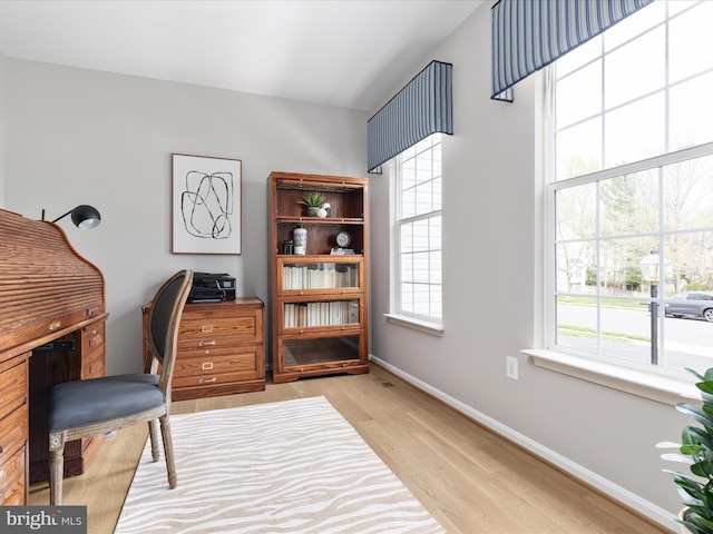 office with light wood-style floors and baseboards