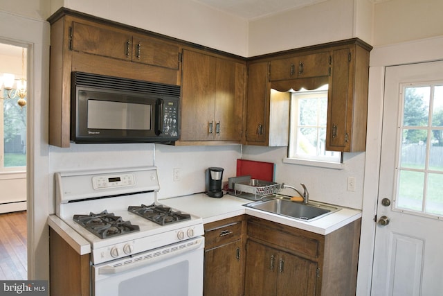 20 Leuckel Ave, Hamilton, NJ 08619 - kitchen featuring white range with gas stovetop, black microwave, a sink, and light countertops