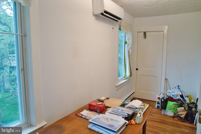 20 Leuckel Ave, Hamilton, NJ 08619 - home office featuring a wall mounted air conditioner, wood finished floors, a baseboard radiator, and a textured ceiling