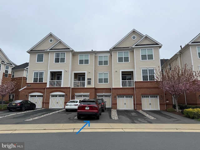 23266 Southdown Manor Ter Unit 102, Ashburn, VA 20148 - townhome / multi-family property featuring driveway, a garage, and brick siding