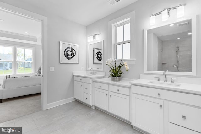 full bath featuring a tile shower, ensuite bathroom, vanity, visible vents, and baseboards