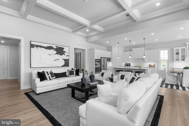 living area featuring visible vents, recessed lighting, coffered ceiling, light wood finished floors, and beam ceiling