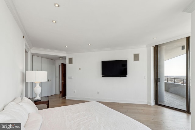 bedroom featuring baseboards, access to exterior, ornamental molding, and wood finished floors
