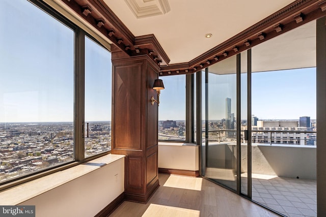 unfurnished sunroom with a city view