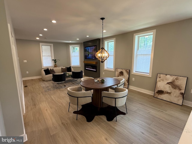 dining room with light wood-style floors, recessed lighting, baseboards, and a chandelier