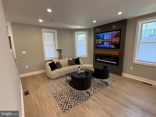 living area featuring wood finished floors, recessed lighting, and baseboards