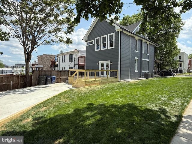 back of property with a wooden deck and central air condition unit