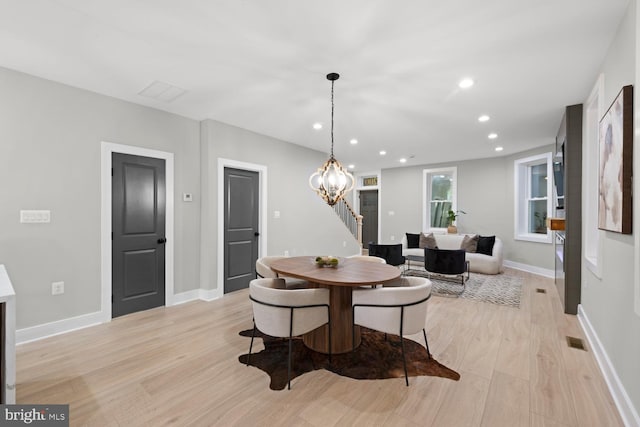 dining area featuring light wood-style floors, recessed lighting, baseboards, and a chandelier