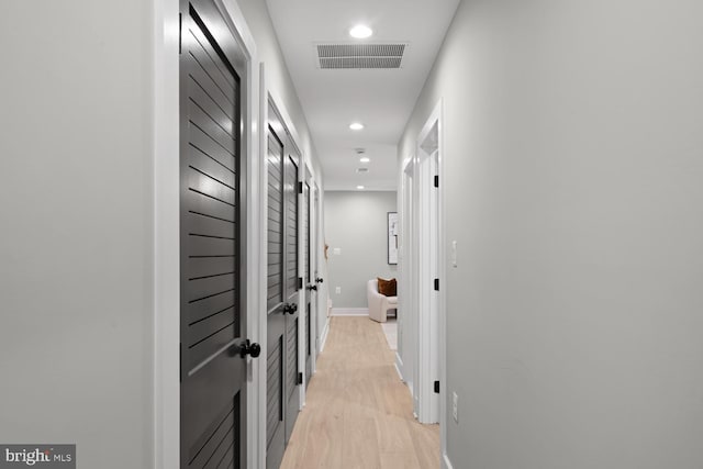 corridor with recessed lighting and baseboards