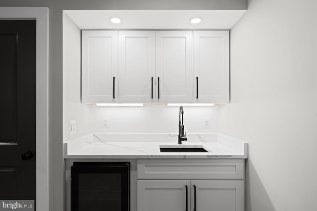 bar with wine cooler, a sink, and recessed lighting
