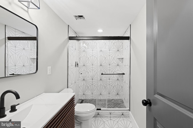 bathroom with a shower stall, toilet, tile patterned flooring, vanity, and recessed lighting