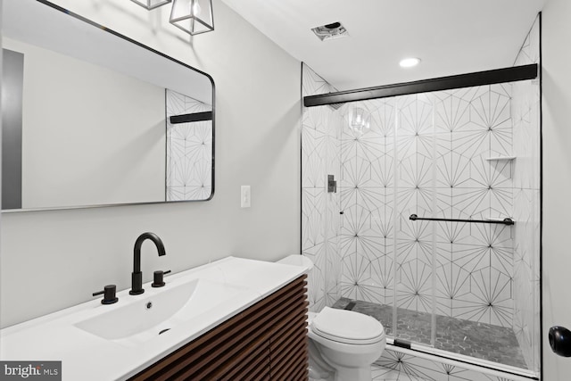 bathroom featuring toilet, a shower stall, vanity, and recessed lighting