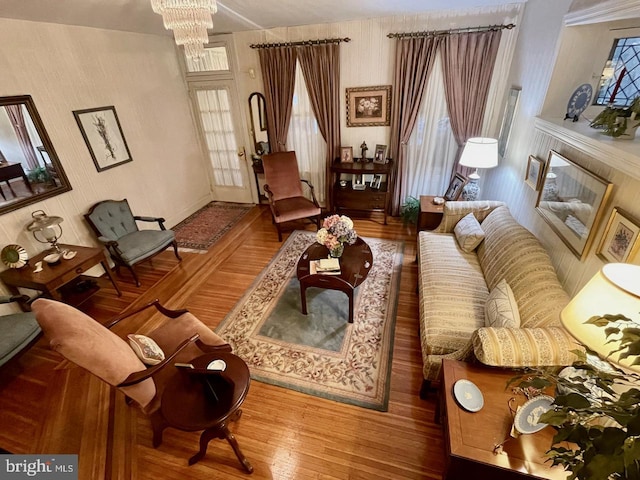 living room with an inviting chandelier and wood finished floors