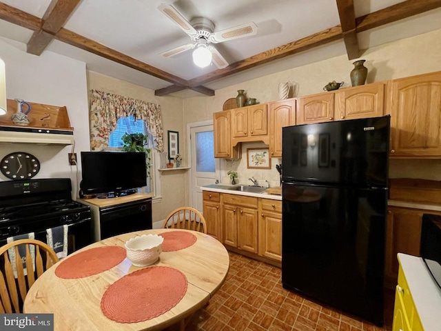 kitchen with coffered ceiling, a ceiling fan, black appliances, and brick patterned floor
