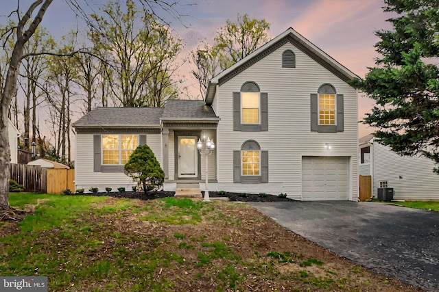 6135 Rainbow Dr, Elkridge, MD 21075 - view of front of house with central AC, a shingled roof, a garage, fence, and driveway
