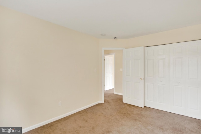6135 Rainbow Dr, Elkridge, MD 21075 - unfurnished bedroom with light carpet, baseboards, and a closet