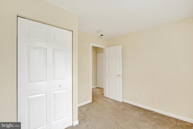 6135 Rainbow Dr, Elkridge, MD 21075 - unfurnished bedroom with a closet, baseboards, and light colored carpet