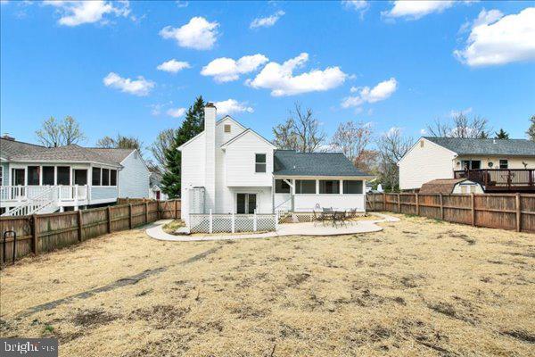 6135 Rainbow Dr, Elkridge, MD 21075 - rear view of house with a fenced backyard and a patio