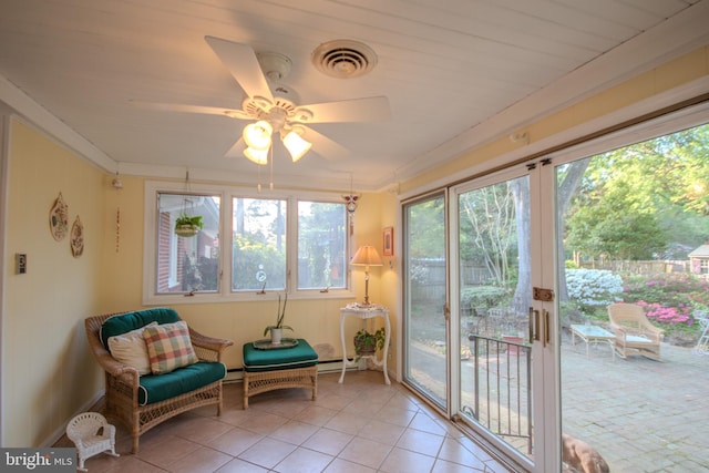 sunroom / solarium featuring a baseboard radiator, tile patterned flooring, and visible vents
