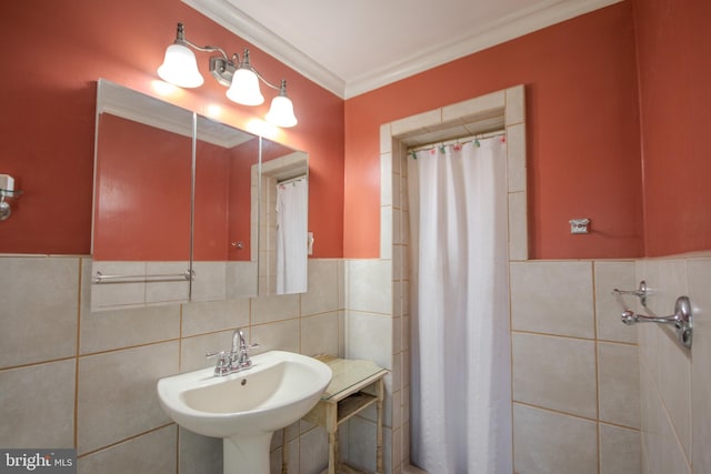 bathroom featuring a sink, tile walls, and wainscoting