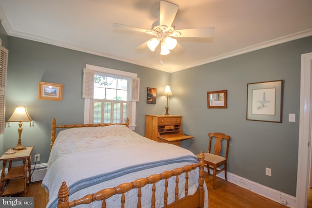 bedroom featuring crown molding, baseboards, ceiling fan, and wood finished floors