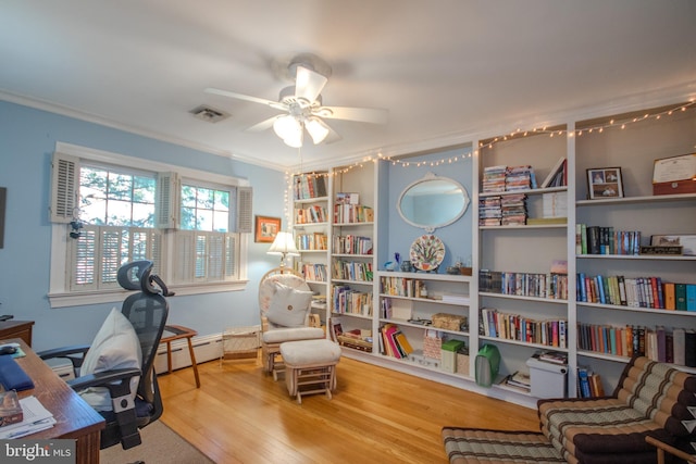 interior space featuring visible vents, ornamental molding, wood finished floors, a baseboard radiator, and a ceiling fan