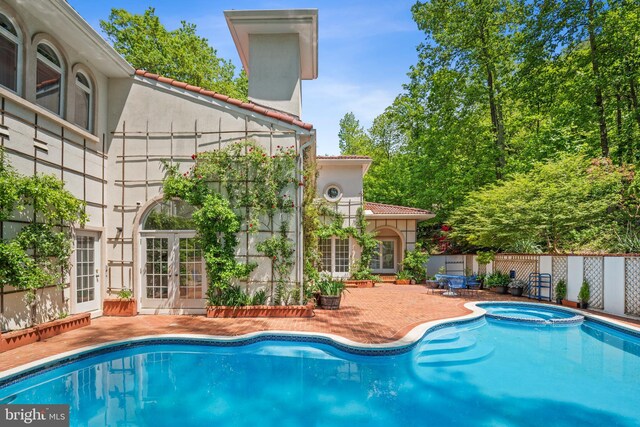 1405 N Pegram St, Alexandria, VA 22304 - view of pool with a pool with connected hot tub, fence, french doors, and a patio area