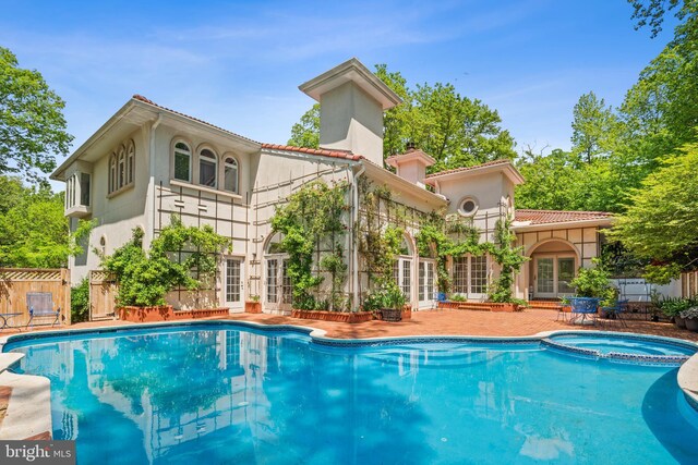 1405 N Pegram St, Alexandria, VA 22304 - rear view of property featuring a chimney, stucco siding, french doors, and a pool with connected hot tub