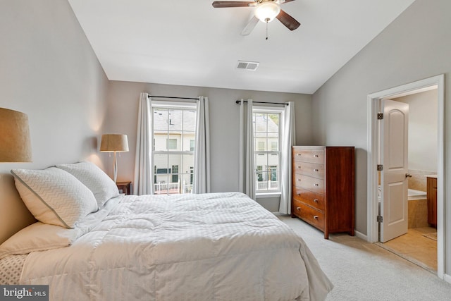 bedroom with visible vents, a ceiling fan, vaulted ceiling, and light carpet