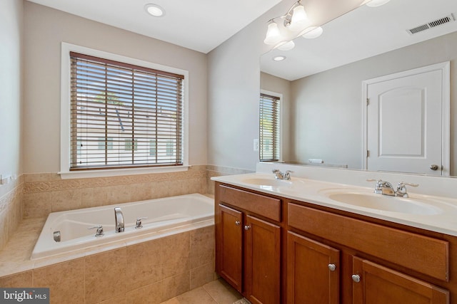bathroom featuring visible vents, a sink, a garden tub, and double vanity