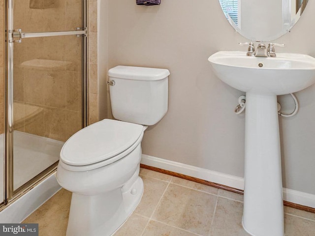 full bath with baseboards, tile patterned flooring, a stall shower, and toilet