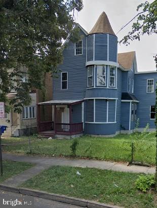 victorian home featuring a front yard
