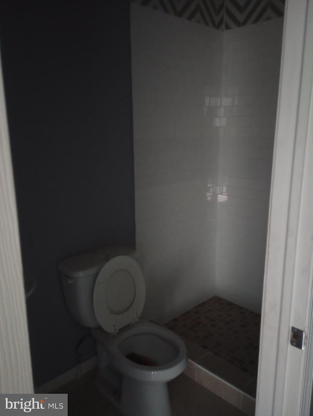 full bath featuring toilet and a shower stall
