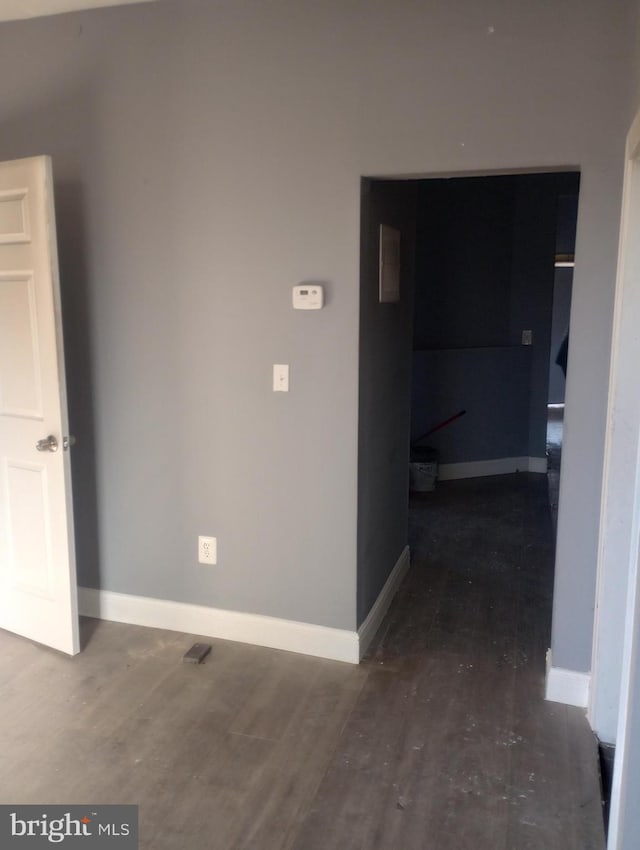 interior space featuring dark wood-type flooring and baseboards
