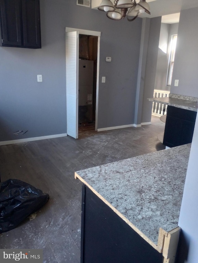 unfurnished dining area featuring visible vents, baseboards, and an inviting chandelier