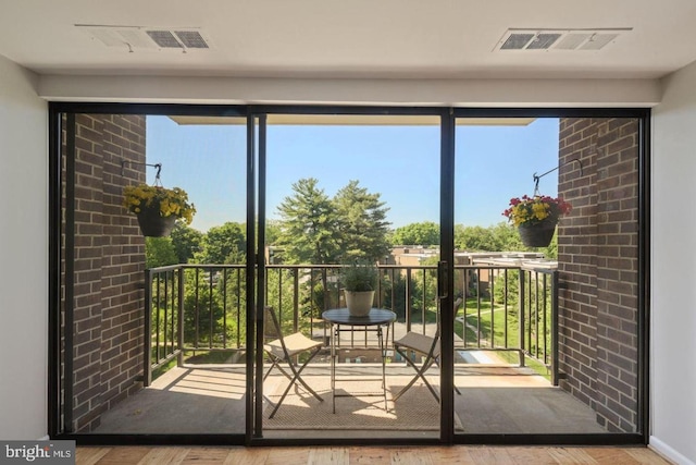 doorway featuring visible vents and wood finished floors