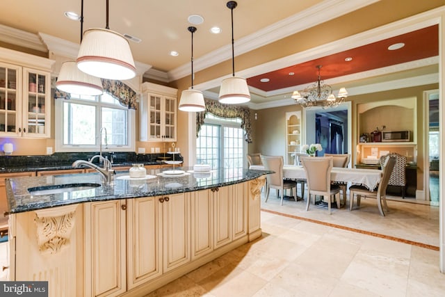 1100 Washingtonville Dr, Baltimore, MD 21210 - kitchen with cream cabinets, stainless steel microwave, hanging light fixtures, and ornamental molding
