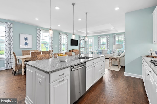 kitchen featuring open floor plan, dishwasher, a sink, and dark wood finished floors
