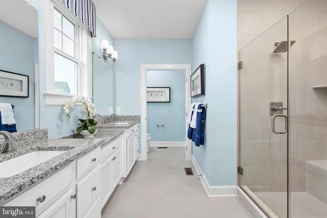 bathroom with a sink, baseboards, and a shower stall