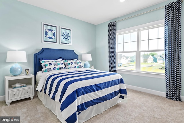 bedroom featuring baseboards and carpet