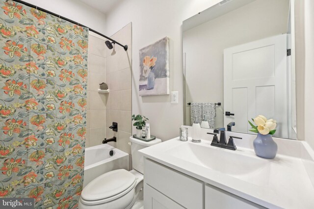 full bath with shower / tub combo, toilet, and vanity