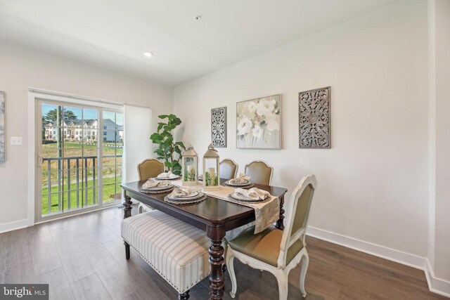 dining room with baseboards, wood finished floors, and recessed lighting