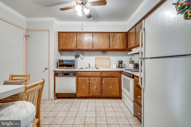 9 Dennison Dr, East Windsor, NJ 08520 - kitchen with brown cabinets, light countertops, a ceiling fan, a sink, and white appliances