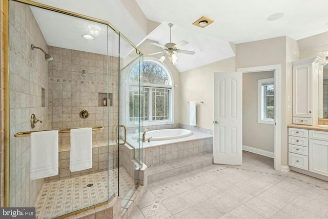 bathroom featuring vanity, vaulted ceiling, a stall shower, ceiling fan, and a garden tub